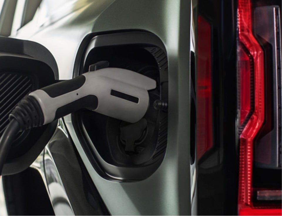 Close up of charging port with charger plugged in on a GMC Hummer EV SUV - Larkin's GMC in Tomah WI